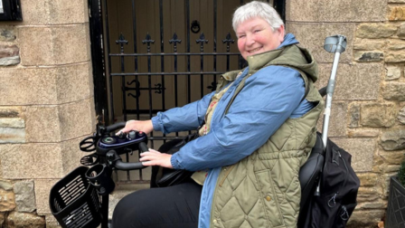 Dog grooming student, Joanne Bolton, in her mobility scooter.